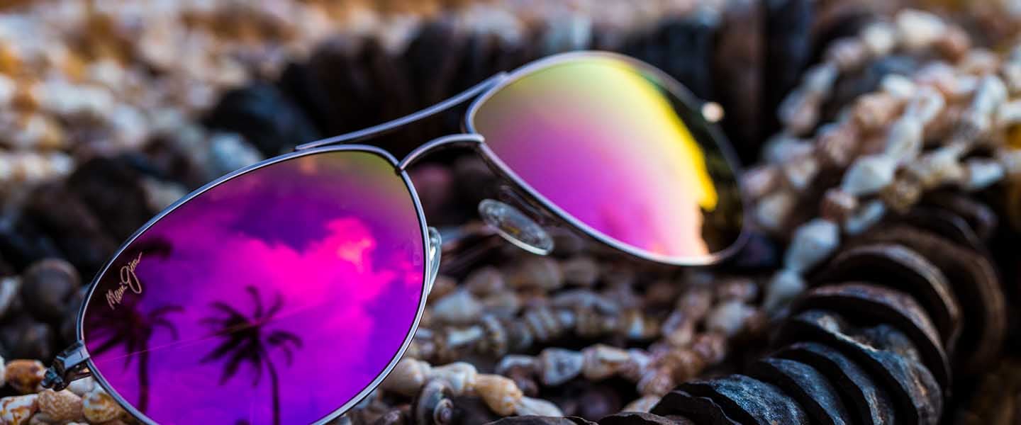 rose gold aviator with pink lenses displayed on top of shells