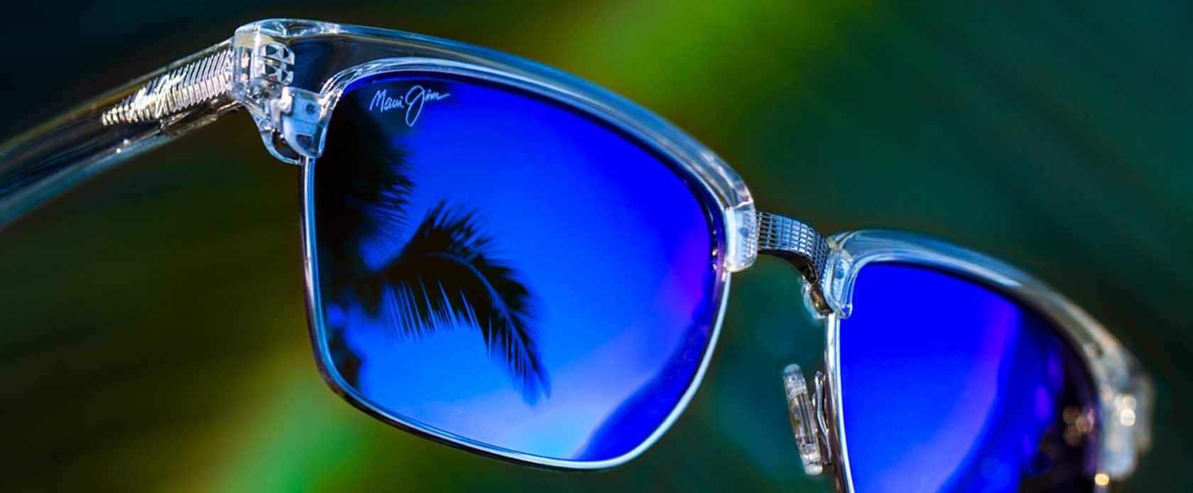 clear frame sunglass with blue lenses with sky reflection