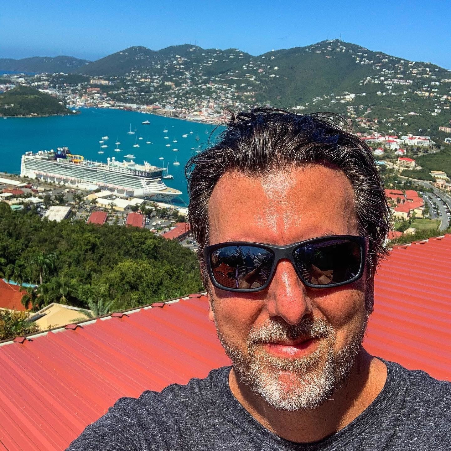 Man wearing sunglasses above ocean bay