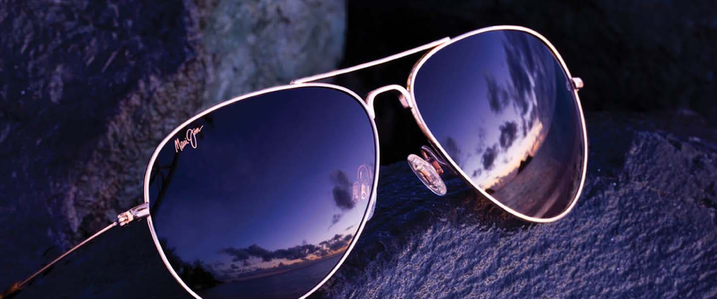 aviator sunglasses displayed on wet rock