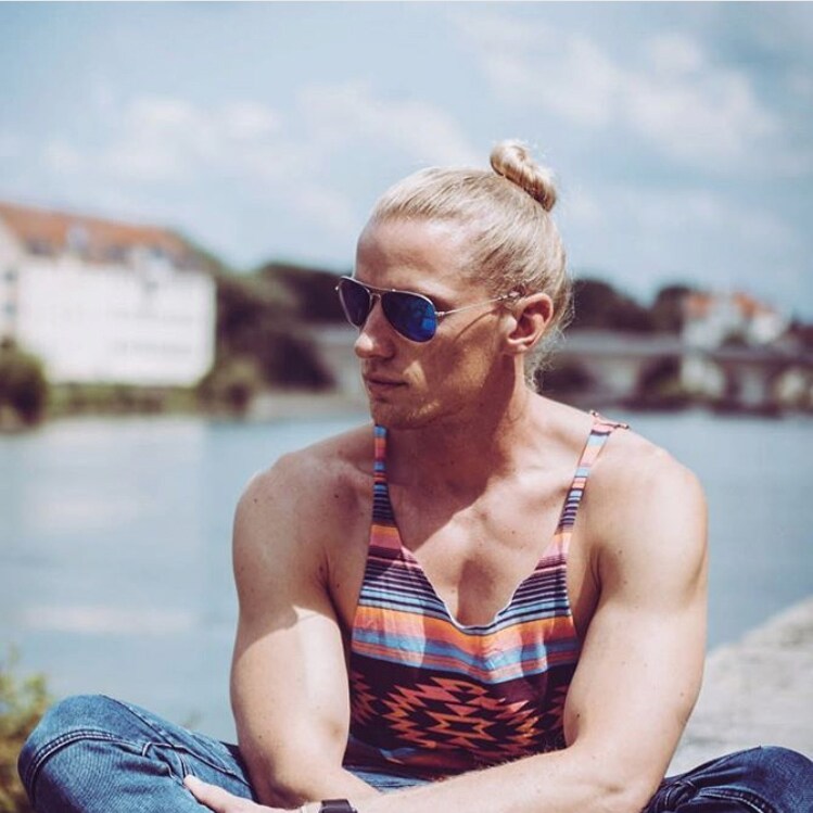 Blonde man sitting cross legged wearing Blue Hawaii Mavericks
