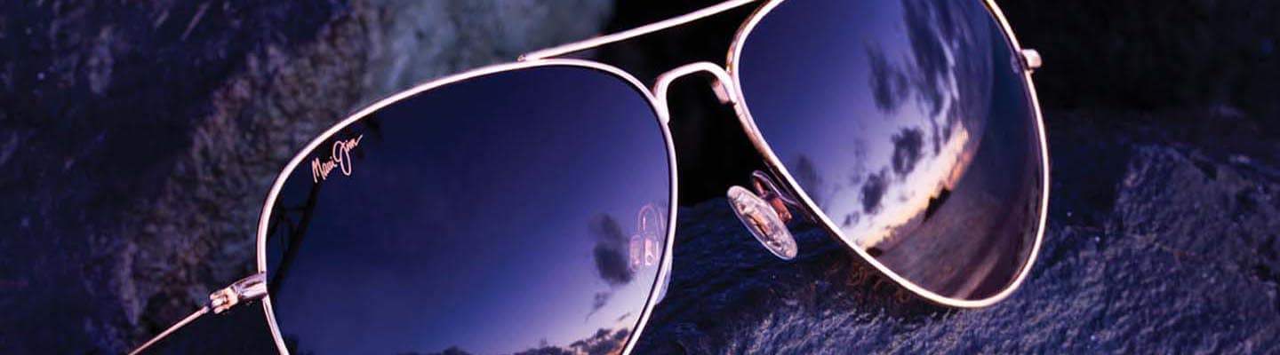 aviator sunglasses displayed on wet rock