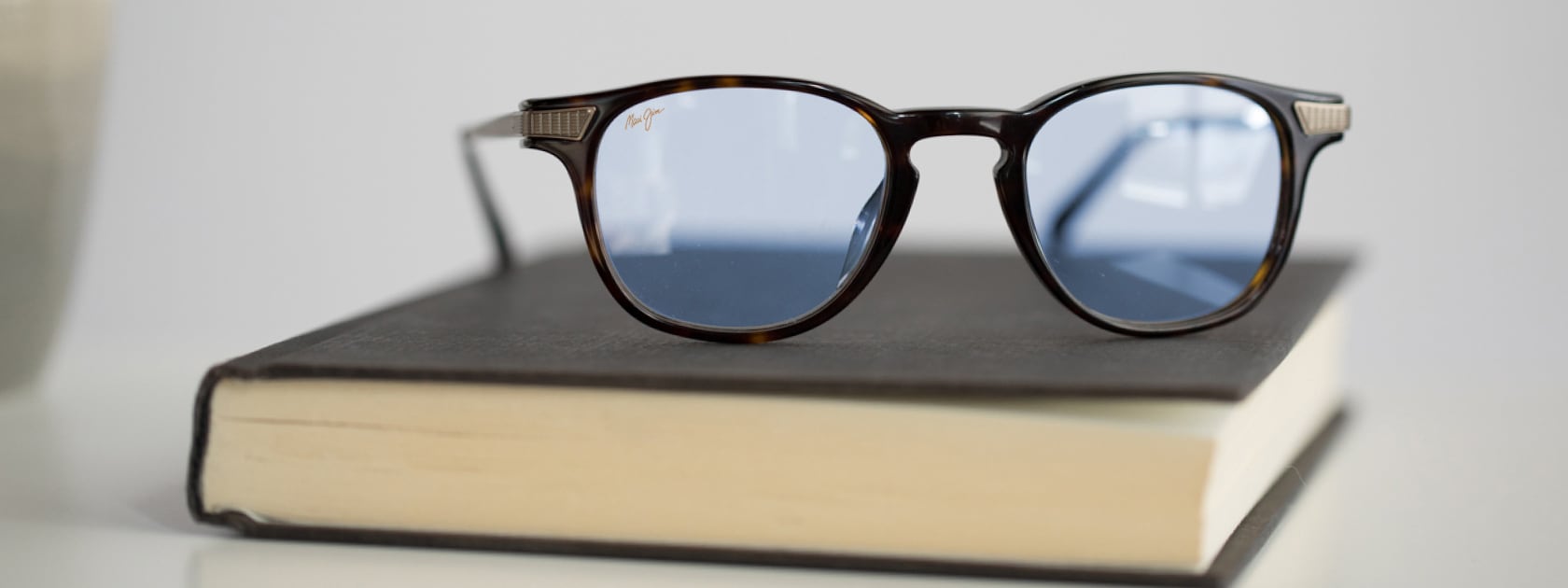 ophthalmic glasses sitting on book