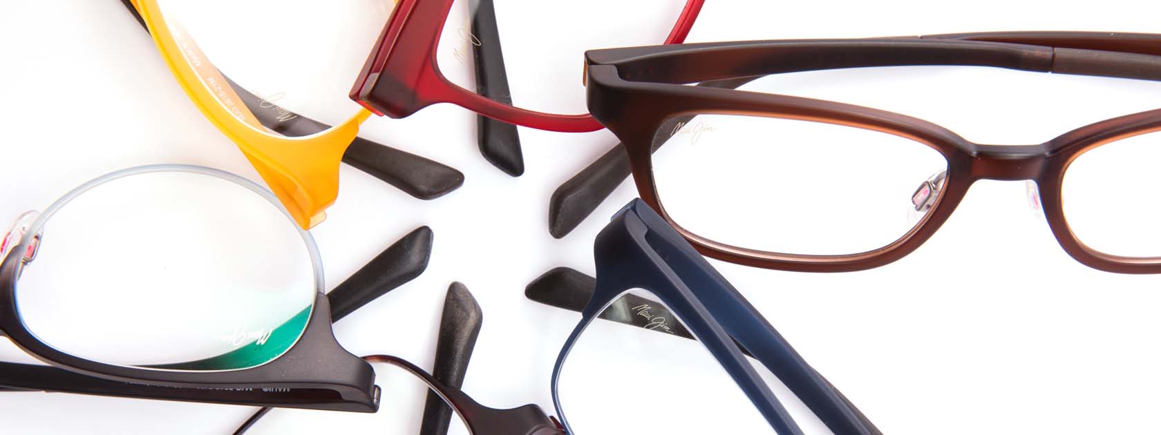 six pairs of ophthalmic glasses arranged in a star pattern over white background
