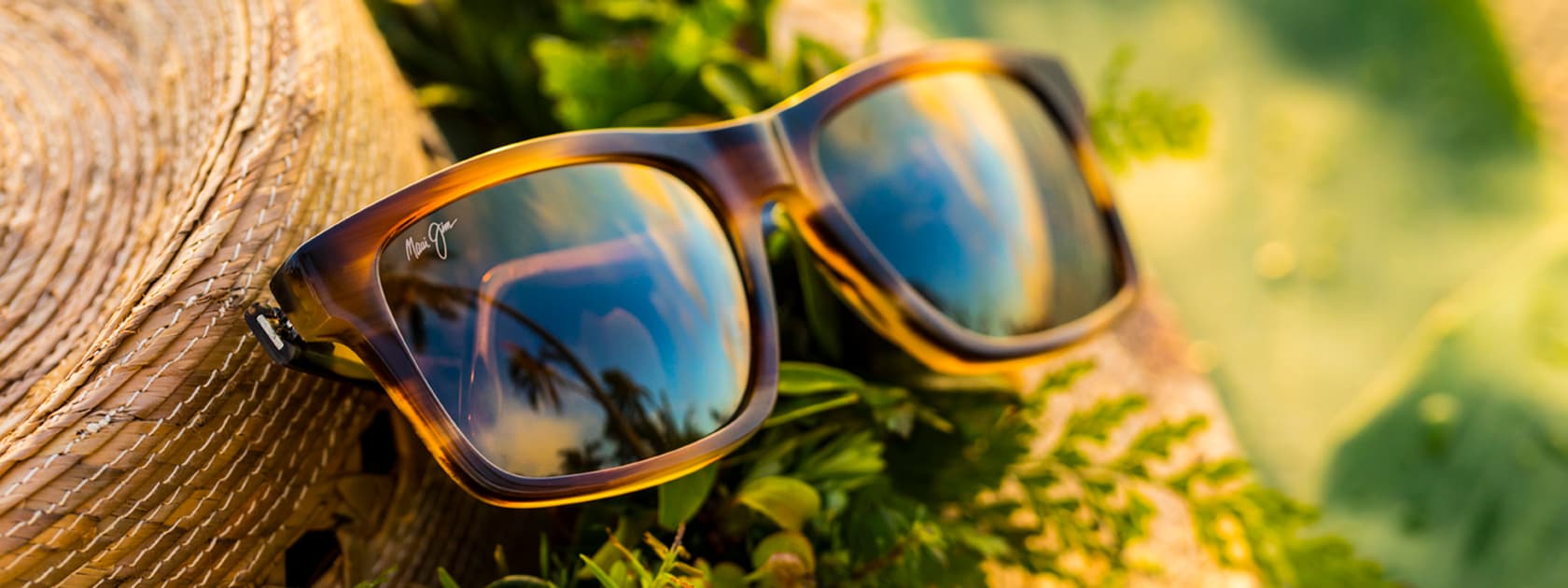 Brown Rectangular Glasses Resting on Sun Hat