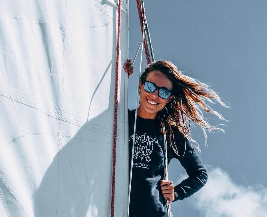 Woman standing on sailboat